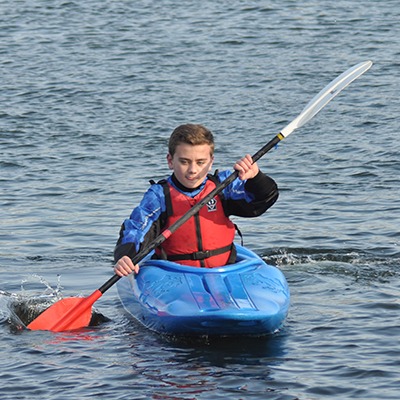 young boy canoeing